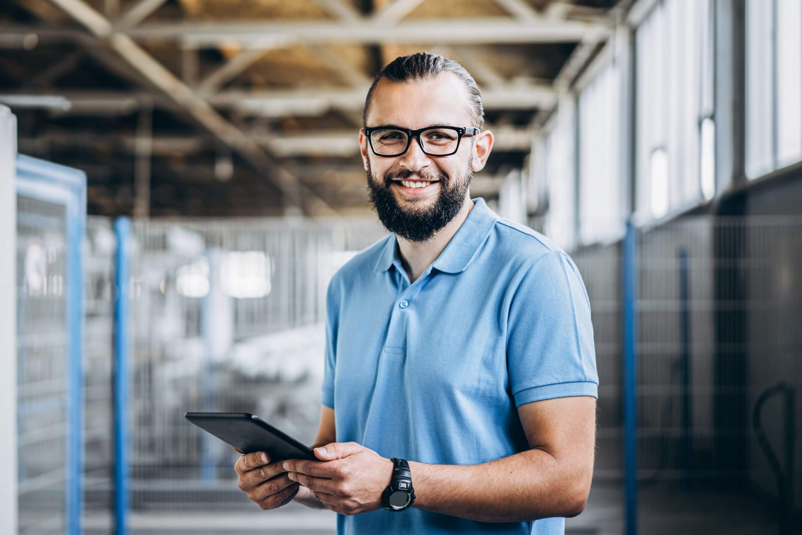 Asset Management Worker with Asset management Software on a Tablet