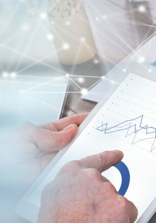 Businessperson analyzing financial charts with tablet computer; panoramic banner